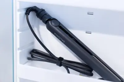 a black umbrella is sitting in a drawer at SATELLITE HOTEL Roppongi 2nd \u30b5\u30c6\u30e9\u30a4\u30c8\u30db\u30c6\u30eb\u516d\u672c\u67282nd in Tokyo