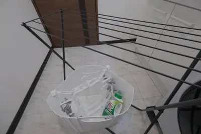 a trash can sitting on the floor under a shelf at Akabane Nishi Masuda House in Tokyo