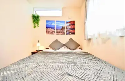 a bedroom with a large bed and a window at \u6e0b\u8c37\u672c\u753a4\u4e01\u76ee in Tokyo