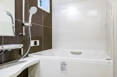 a bathroom with a shower and a white bath tub at \u6e0b\u8c37\u672c\u753a4\u4e01\u76ee in Tokyo