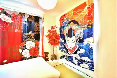 a room with a bed and a painting on the wall at \u6e0b\u8c37\u672c\u753a4\u4e01\u76ee in Tokyo