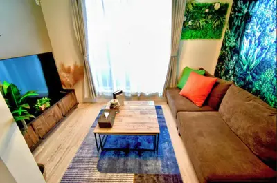 a living room with a couch and a coffee table at \u6e0b\u8c37\u672c\u753a4\u4e01\u76ee in Tokyo