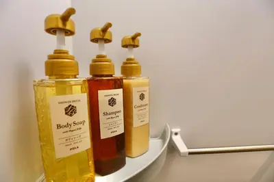 three bottles of essential oils sitting on a shelf at 101 Convenient Ueno Lucky Yado in Tokyo