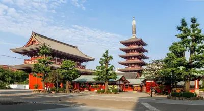 a large building with a tower in a city at 101 Convenient Ueno Lucky Yado in Tokyo