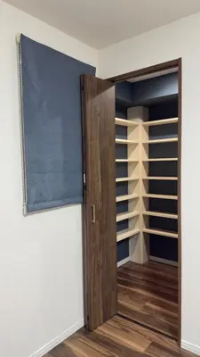 a closet with a wooden door in a room at New open! Ikebukuro smart home \u6728\u6728\u65b0\u9928 in Tokyo