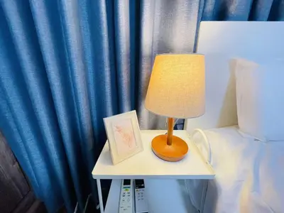 a lamp on a table next to a bed at New open! Ikebukuro smart home \u6728\u6728\u65b0\u9928 in Tokyo