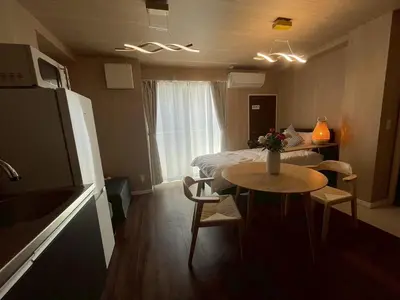 a small room with a bed and a table and a refrigerator at OPEN SALE! Stylish Stay near AKIHABARA! May2025 Open! \u79cb\u8449\u539f CORE HOTEL in Tokyo