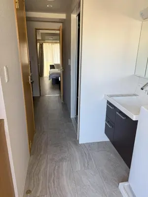 a kitchen with a sink and a hallway at Walk to JR Shinjuku - Grand Écru II 403 - Balcony & Kitchen in Tokyo