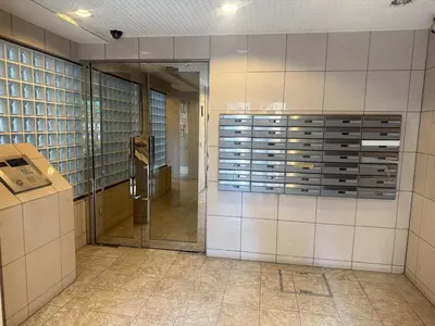 a hallway of a building with a door to a room at Walk to JR Shinjuku - Grand Écru II 403 - Balcony & Kitchen in Tokyo