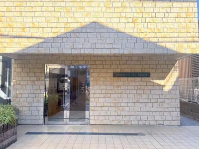 an entrance to a building with a sign on it at Walk to JR Shinjuku - Grand Écru II 403 - Balcony & Kitchen in Tokyo