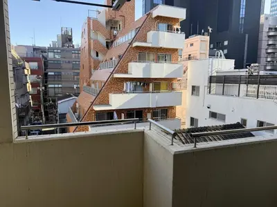a building with a staircase on the side of a building at Walk to JR Shinjuku - Grand Écru II 403 - Balcony & Kitchen in Tokyo