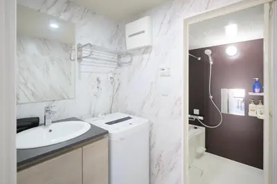 a white bathroom with a sink and a shower at HJ PLACE Takanawa by Tranova in Tokyo