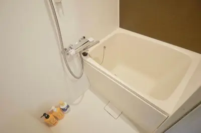 a white bath tub in a bathroom with a sink at HJ PLACE Takanawa by Tranova in Tokyo