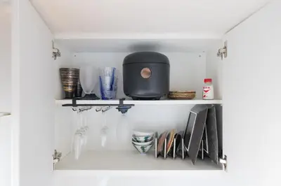 a shelf in a kitchen with wine glasses at \u6771\u4eac\u90fd\u5fc315\u5206 \u6210\u7530\u7a7a\u6e2f1\u6642\u9593 \u99c5\u304b\u3089\u5f92\u6b6910\u5206\u306e\u65b0\u88c5\u30de\u30f3\u30b7\u30e7\u30f3 in Tokyo