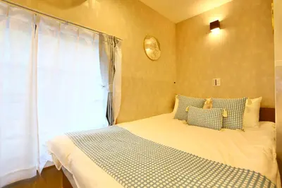 a small bedroom with a bed with a window at 201 Modern Ueno House Lucky Yado in Tokyo