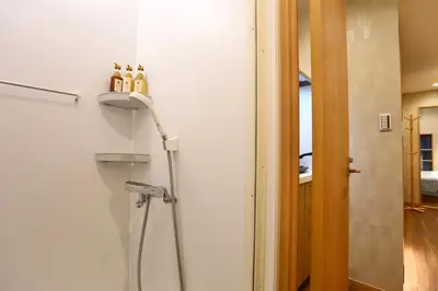 a shower in a bathroom next to a door at 201 Modern Ueno House Lucky Yado in Tokyo