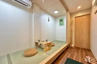 a room with a table and a stool at 201 Modern Ueno House Lucky Yado in Tokyo