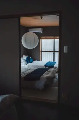 a mirror reflection of a bed in a bedroom at 6-minute walk to Tokyo Skytree Up to 6 people 68 sqm fully renovated direct access to Asakusa, Shibuya, Narita Airport, and Haneda Airport in Tokyo