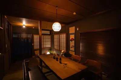 a dining room with a wooden table and chairs at 6-minute walk to Tokyo Skytree Up to 6 people 68 sqm fully renovated direct access to Asakusa, Shibuya, Narita Airport, and Haneda Airport in Tokyo