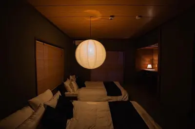 a bedroom with two beds and a light fixture at 6-minute walk to Tokyo Skytree Up to 6 people 68 sqm fully renovated direct access to Asakusa, Shibuya, Narita Airport, and Haneda Airport in Tokyo