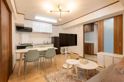 a kitchen and living room with a table and chairs at \u304b\u3064\u3089306 in Tokyo