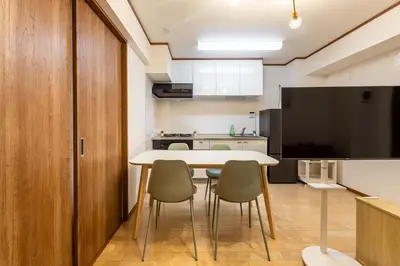 a kitchen and dining room with a table and chairs at \u304b\u3064\u3089306 in Tokyo