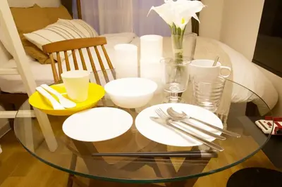 a glass table with white plates and utensils on it at \u30b9\u30ab\u30a4\u30d4\u30a2\u9ad8\u7802 201 in Tokyo