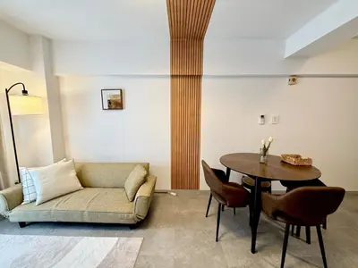 a living room with a couch and a table at MIKASA guesthouse in Tokyo