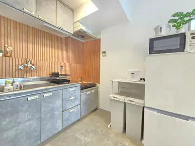 a kitchen with a sink and a refrigerator at MIKASA guesthouse in Tokyo