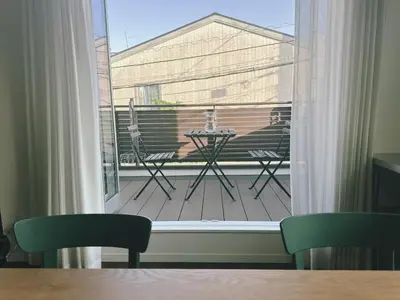 a view of a balcony with a table and chairs at Tokyo Designer Guest House in central Tokyo in Tokyo
