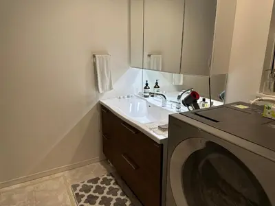 a bathroom with a sink and a washing machine at Tokyo Designer Guest House in central Tokyo in Tokyo