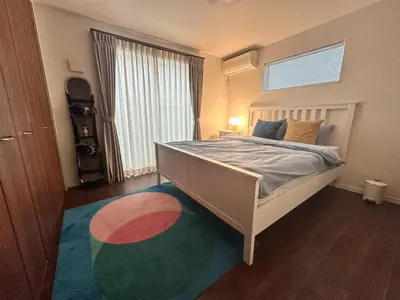 a bedroom with a bed and a large window at Tokyo Designer Guest House in central Tokyo in Tokyo