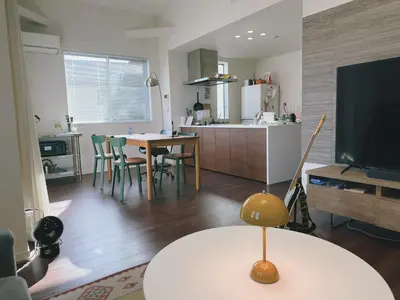 a kitchen and a living room with a table and a tv at Tokyo Designer Guest House in central Tokyo in Tokyo