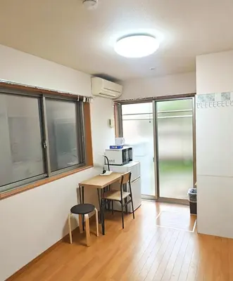 a kitchen with a table and chairs in a room at Senju 103, Relaxed Tokyo Studio in Tokyo