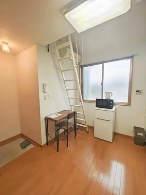 a room with a ladder and a table and a desk at Senju 201, Cozy Tokyo Loft in Tokyo