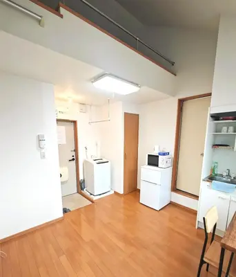 an empty room with a kitchen with white appliances at Senju 202, Restful Tokyo Loft in Tokyo