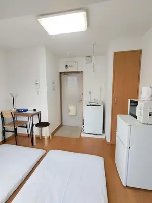 a room with a kitchen and a table and a refrigerator at Senju 202, Restful Tokyo Loft in Tokyo