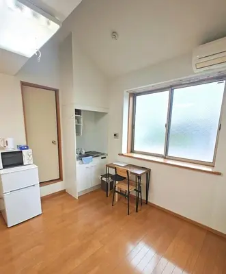 a kitchen with a table and chairs in a room at Senju 202, Restful Tokyo Loft in Tokyo