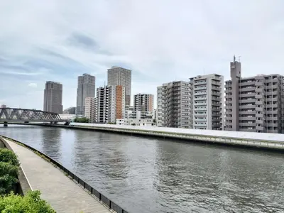 a river in a city with buildings and a bridge at Senju 203, Relaxed Tokyo Loft in Tokyo