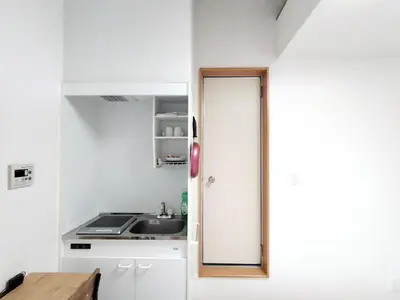 a small kitchen with white cabinets and a sink at Senju 203, Relaxed Tokyo Loft in Tokyo