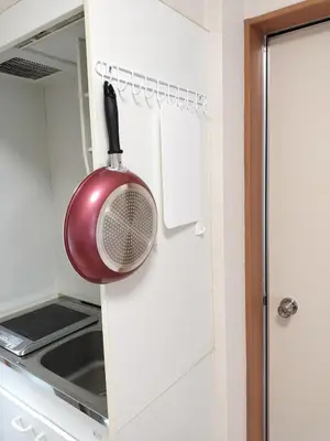 a red pot hanging from a wall in a kitchen at Senju 203, Relaxed Tokyo Loft in Tokyo