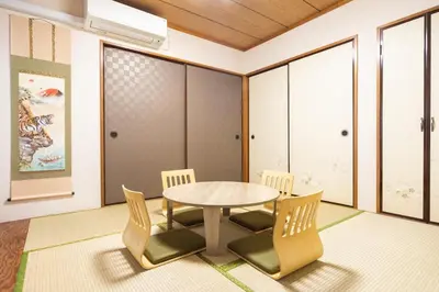 a dining room with a table and chairs at Anime2 in Tokyo