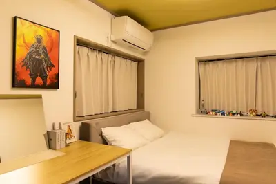 a small room with a bed and a desk and a window at Anime2 in Tokyo
