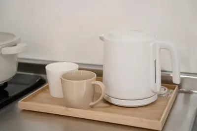 two cups sitting on a cutting board with a appliance at 大田Nishikōjiya hotel-OT0368 in Tokyo