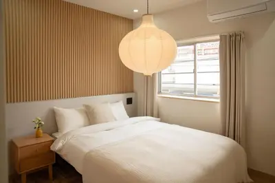 a bedroom with a white bed and a pendant light at 大田Nishikōjiya hotel-OT0368 in Tokyo