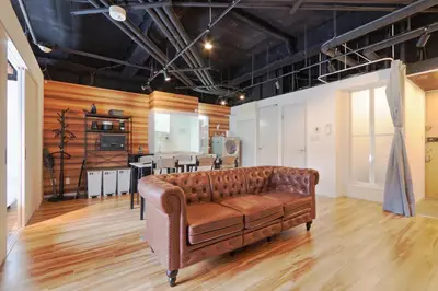 a leather couch in a room with a kitchen at Steps from Shibuya Crossing Roof Top A in Tokyo