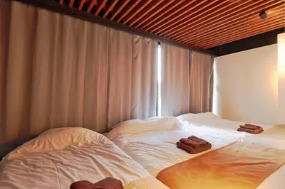 two beds sitting next to each other in a room at Steps from Shibuya Crossing Roof Top A in Tokyo