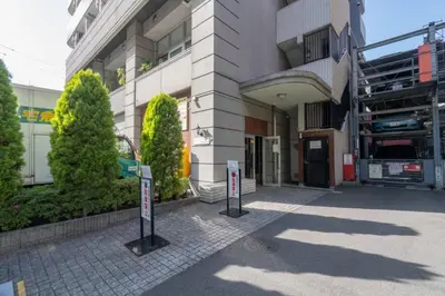 a building with two parking signs in front of it at Stay in the heart of Shibuya in Tokyo