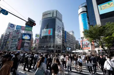a crowd of people crossing a street in a city at Stay in the heart of Shibuya in Tokyo