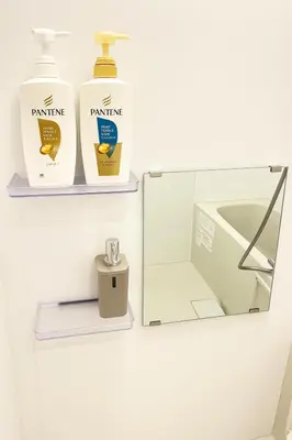 a bathroom with two bottles of detergent and a sink at \u6c60\u888b \u5de3\u9d28 YMhotel \u6700\u592718\u540d\u53ef-ikebukuro sugamo- in Tokyo